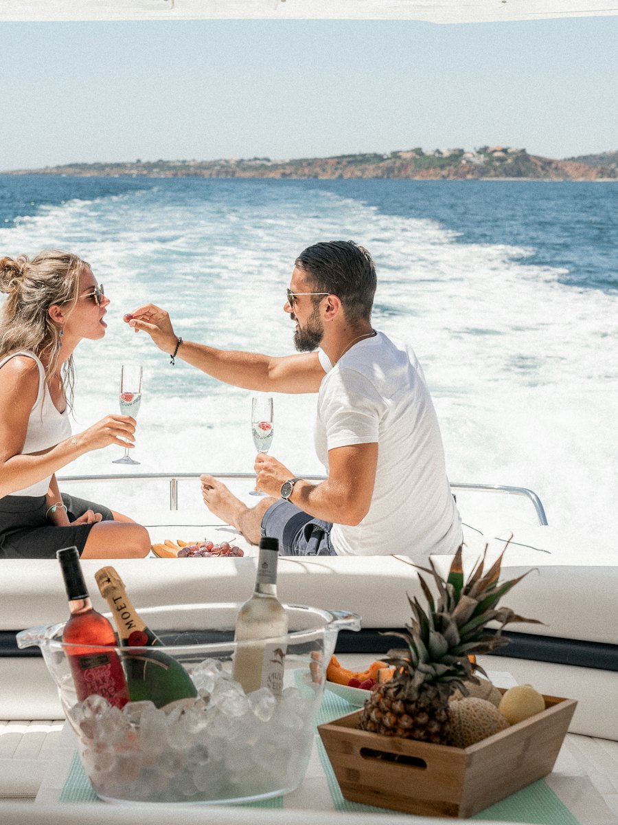 Couple sharing champagne on the stern of a yacht